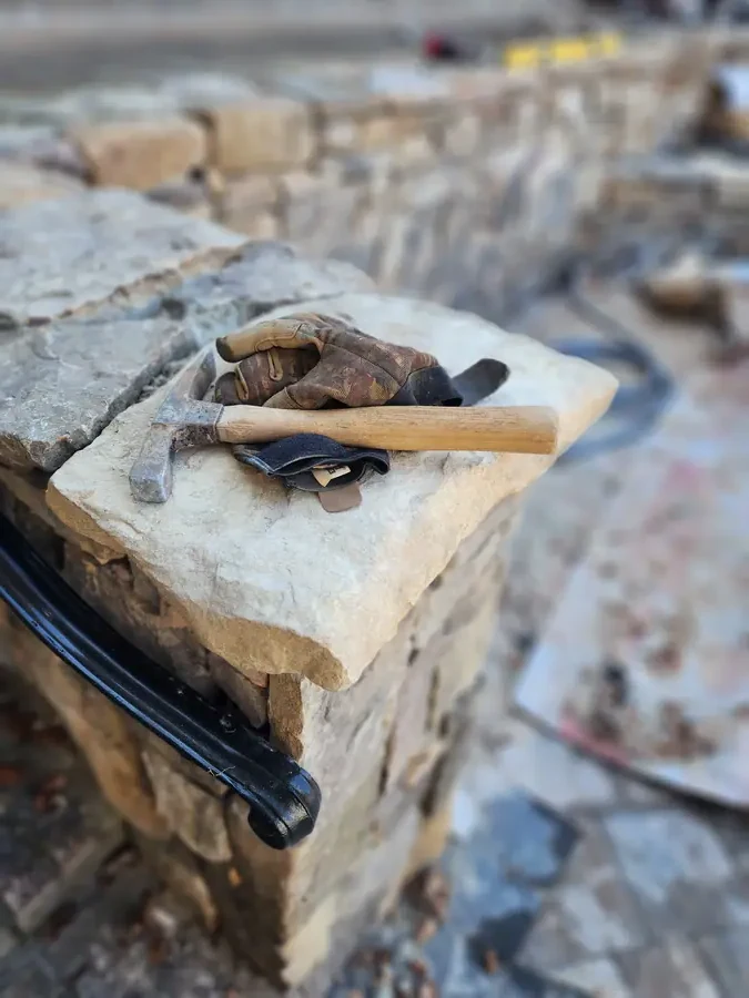 A carved stone piece cut by hand and set into the landscape — custom work most crews won't touch. We've been serving the Upstate for more than 30 years — what can we build for you?
