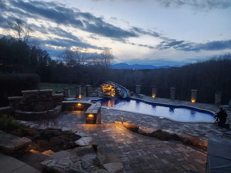 Paver pool deck and raised spa set to catch the ridgeline at dusk. This custom pool restoration in Campobello, SC frames a gorgeous view of the Blue Ridge.